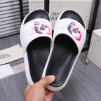 Alexander McQueen slide sandals, white upper with colorful skull print, black footbed