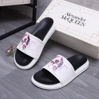 Alexander McQueen slide sandals, pair view; white uppers with red/blue skull artwork