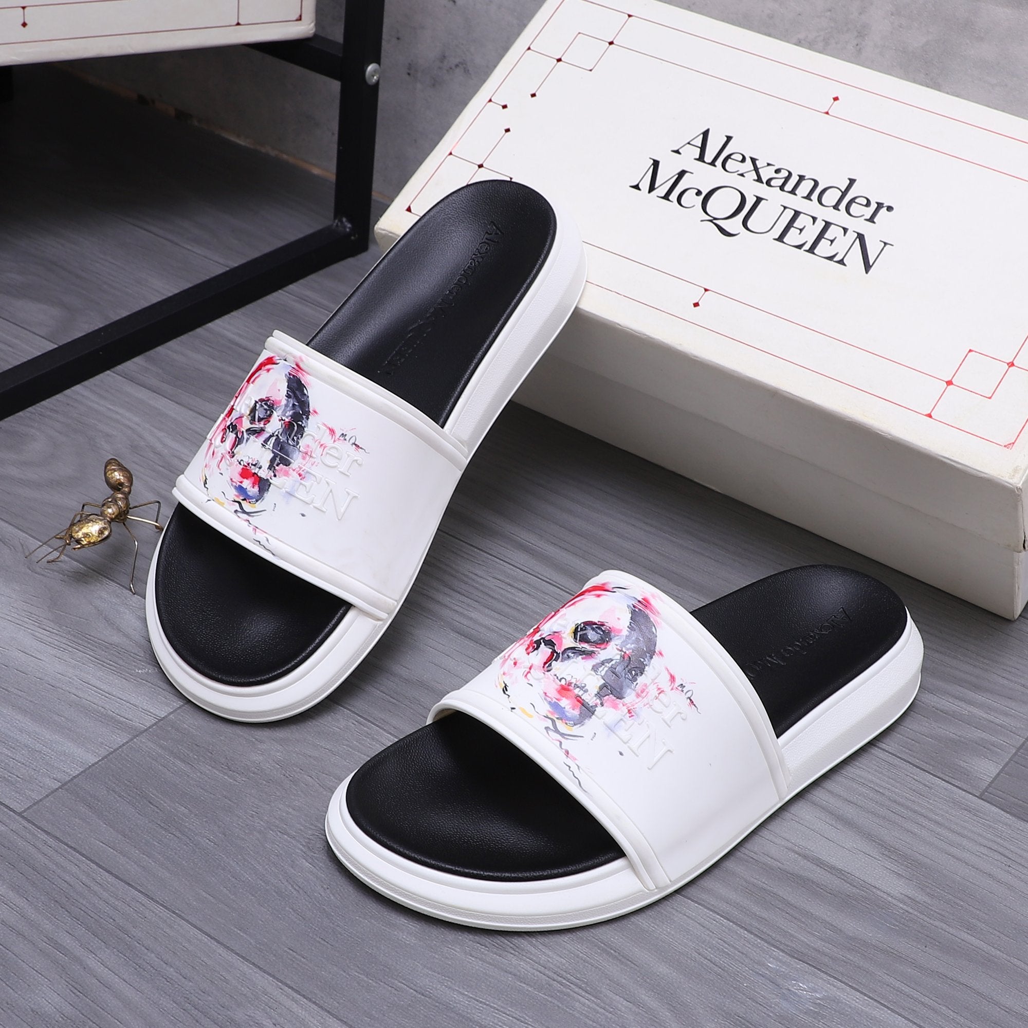 Alexander McQueen slide sandals, pair view; white uppers with red/blue skull artwork