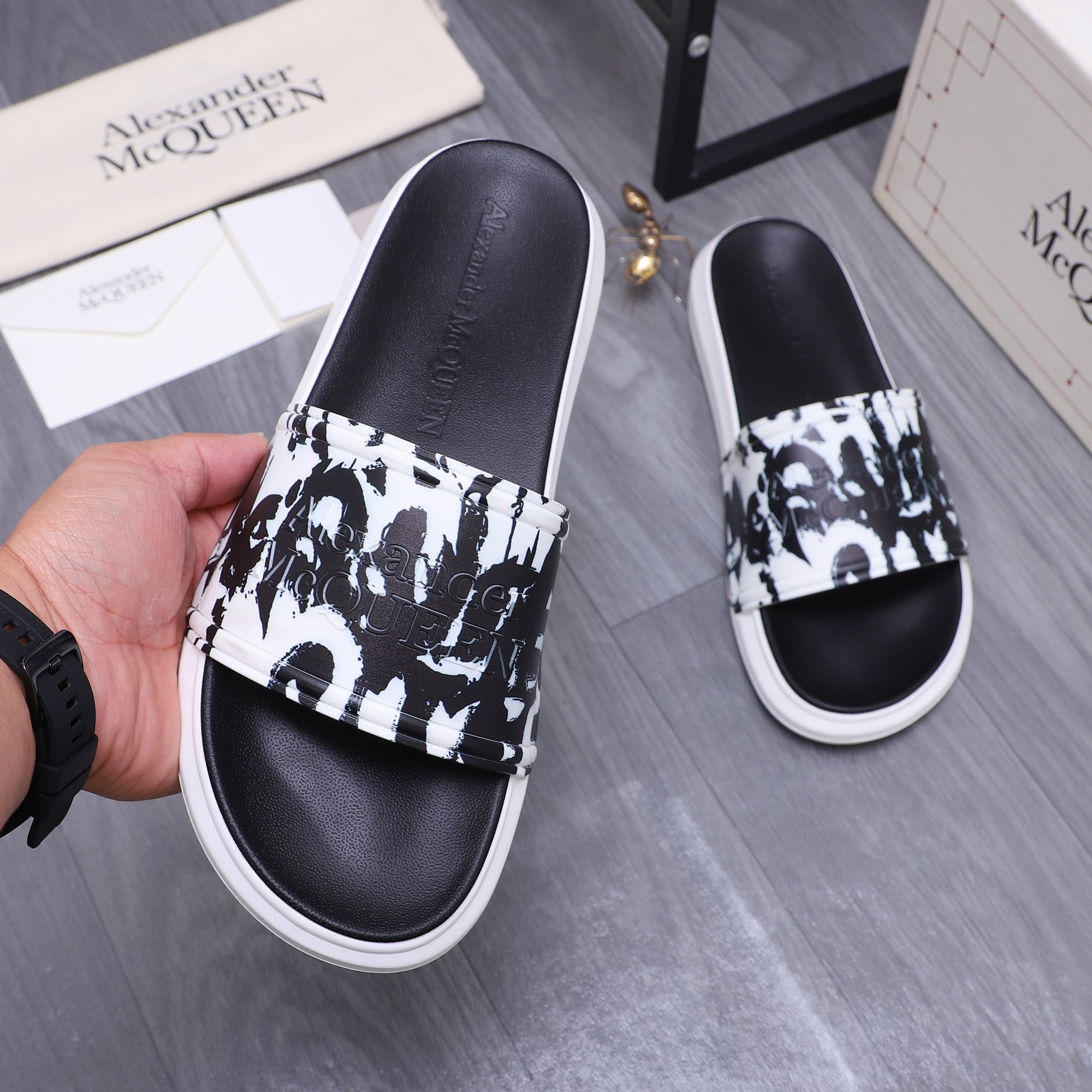 Alexander McQueen slide sandals, black leather upper with black-and-white graphic band