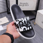 Alexander McQueen slide sandals, black sole with black-and-white graphic strap