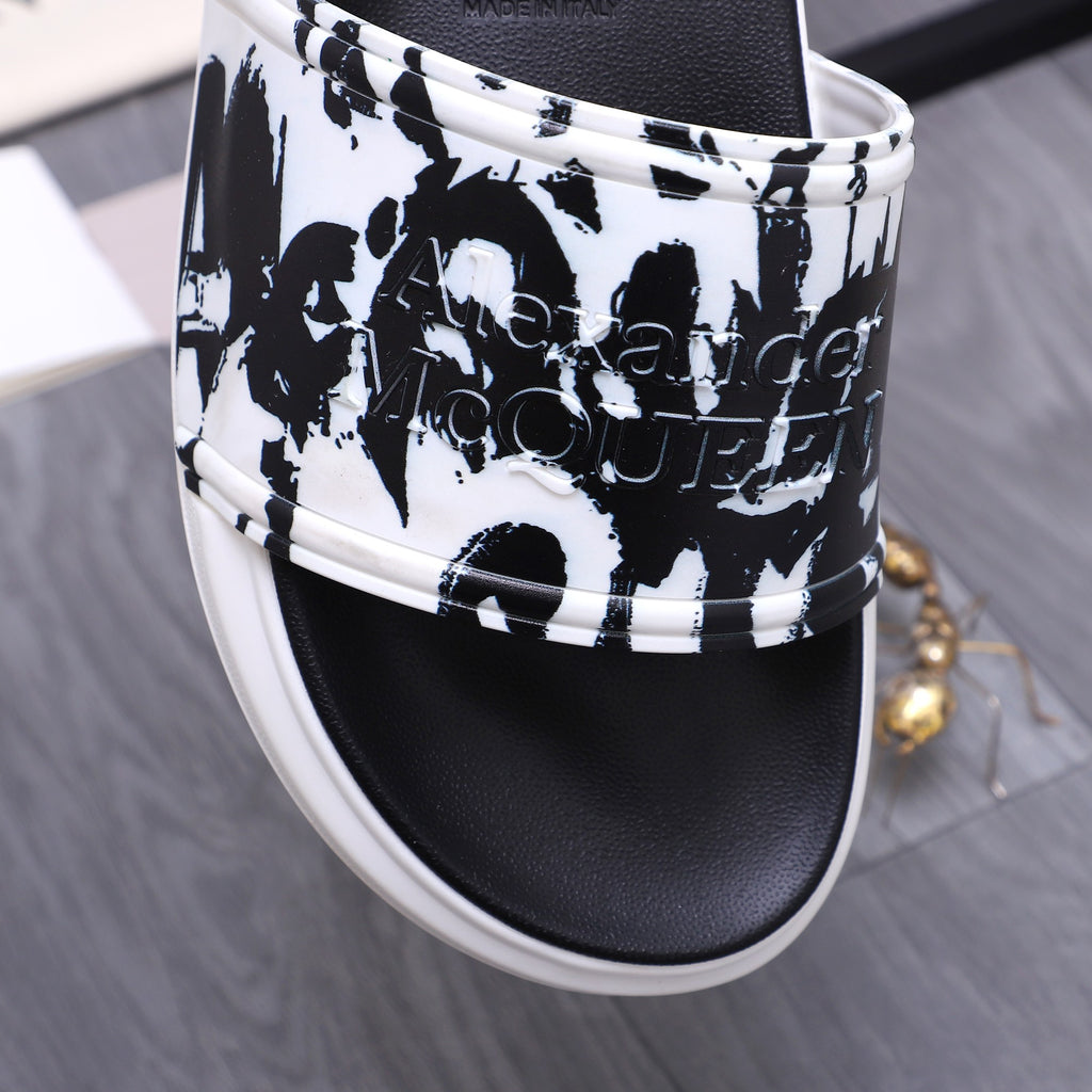 Alexander McQueen slide sandals close-up of black-and-white graphic upper and white edge