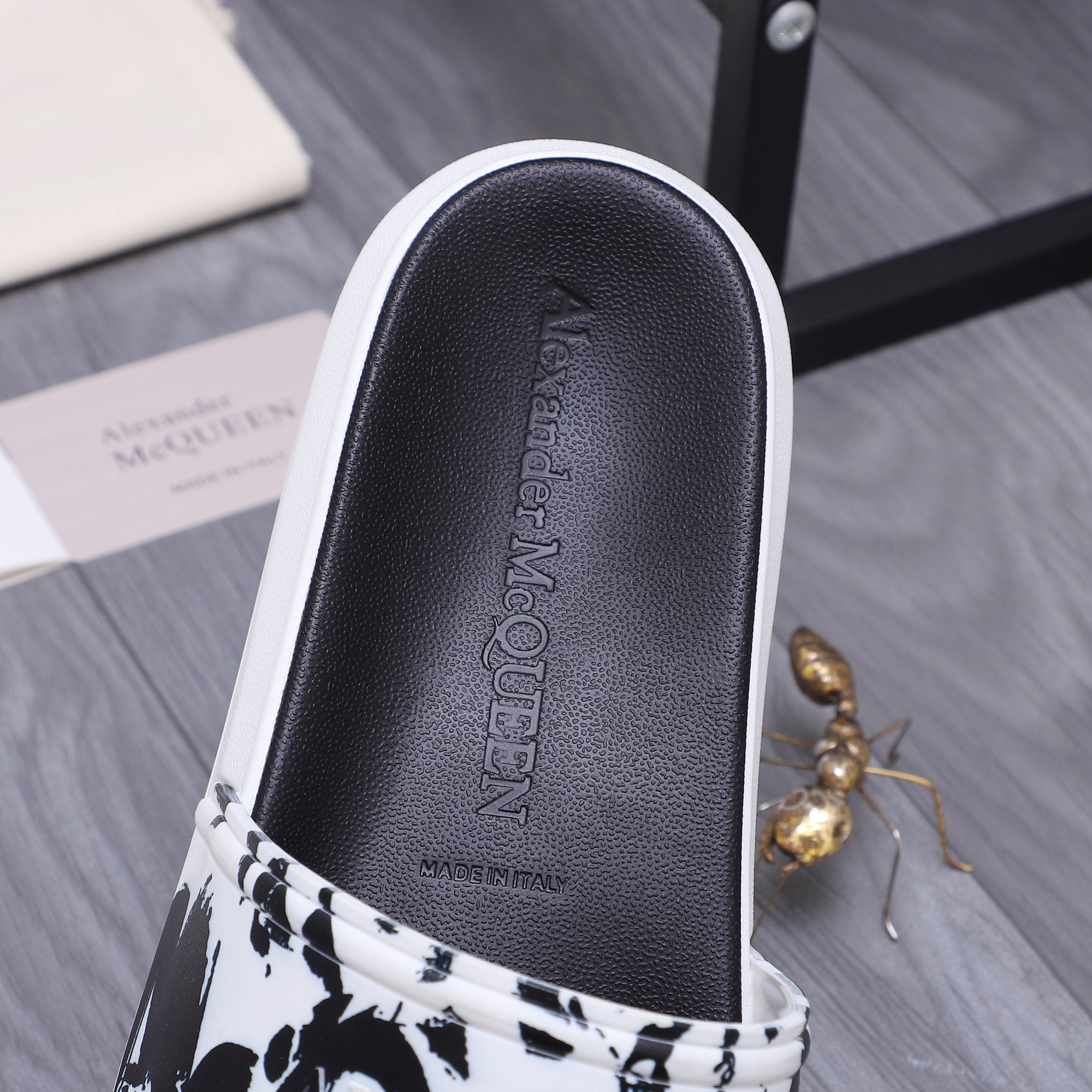 Alexander McQueen slide sandal insole, black leather with embossed brand lettering