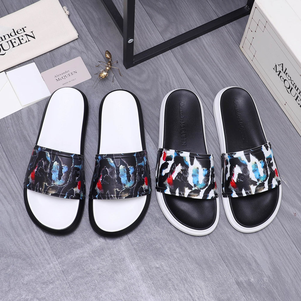 Black slide sandals with white footbeds and multicolor abstract printed straps