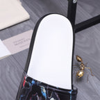Close-up of black slide sandal with white footbed and multicolor abstract strap