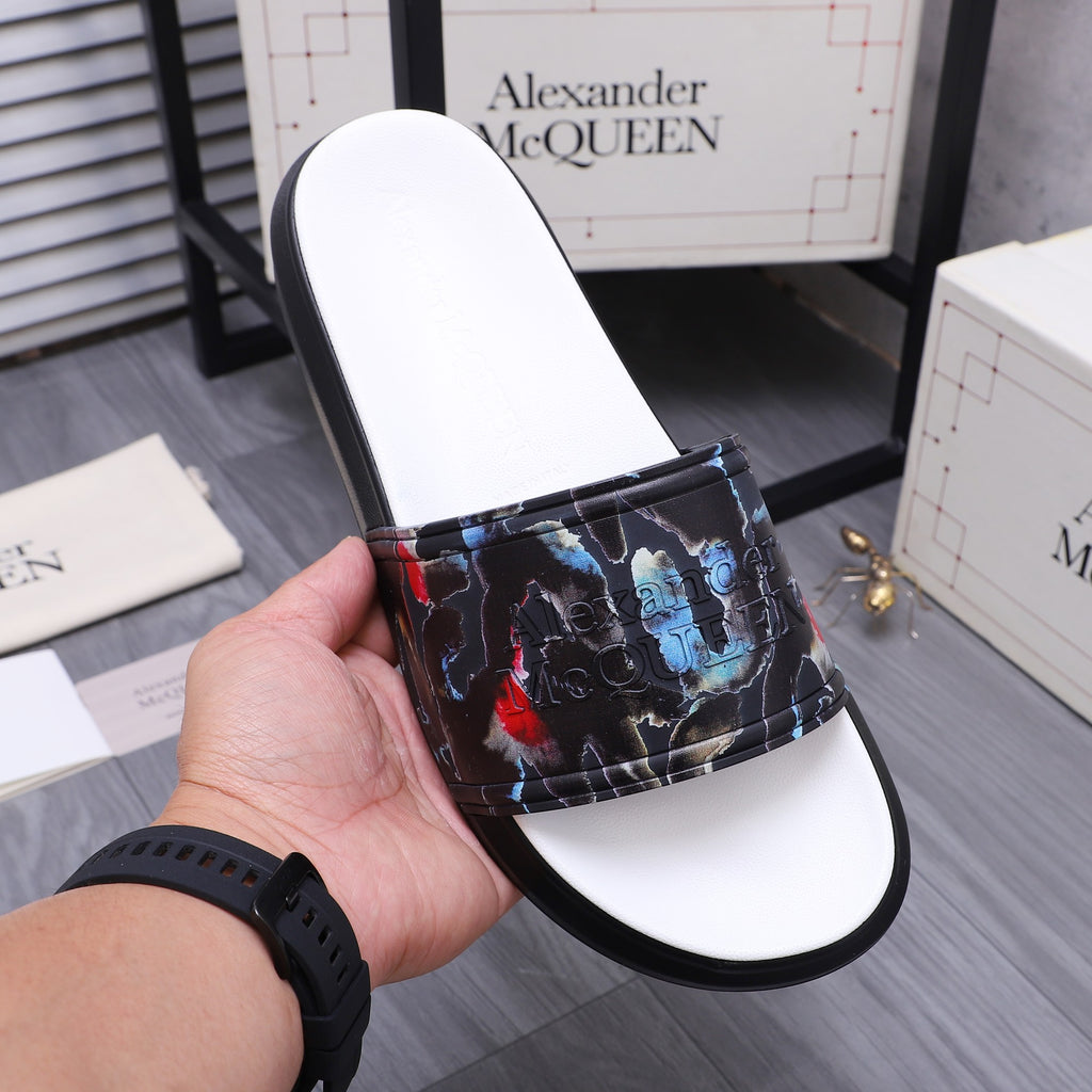Single black slide sandal with white footbed and multicolor abstract strap print