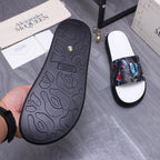 Black rubber outsole of slide sandal with textured tread pattern