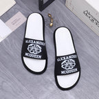 Alexander McQueen slide sandals, black logo bands on white footbeds