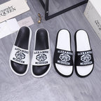 Alexander McQueen slide sandals, black straps with logo print and white footbed