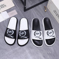 Alexander McQueen slide sandals, white and black leather with large MC logo strap