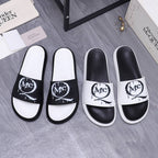 Alexander McQueen slide sandals, white and black leather with large MC logo strap