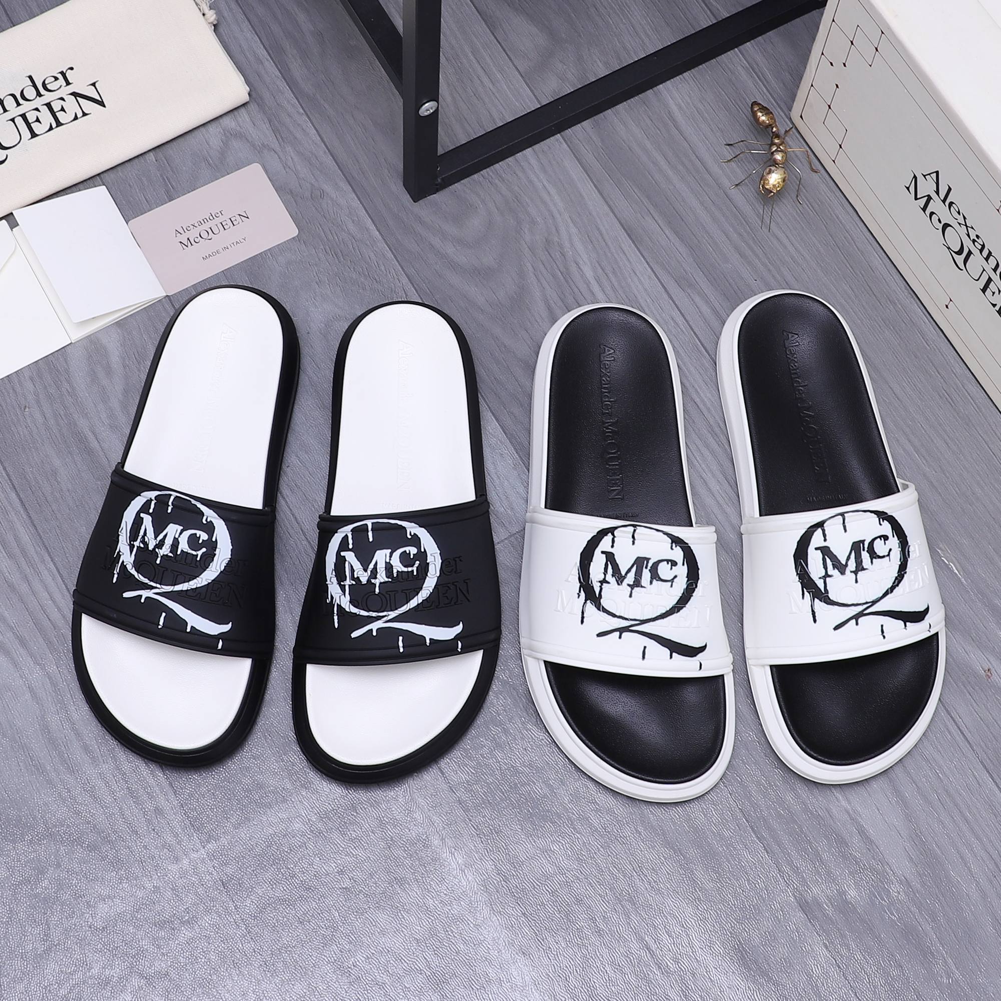 Alexander McQueen slide sandals, white and black leather with large MC logo strap