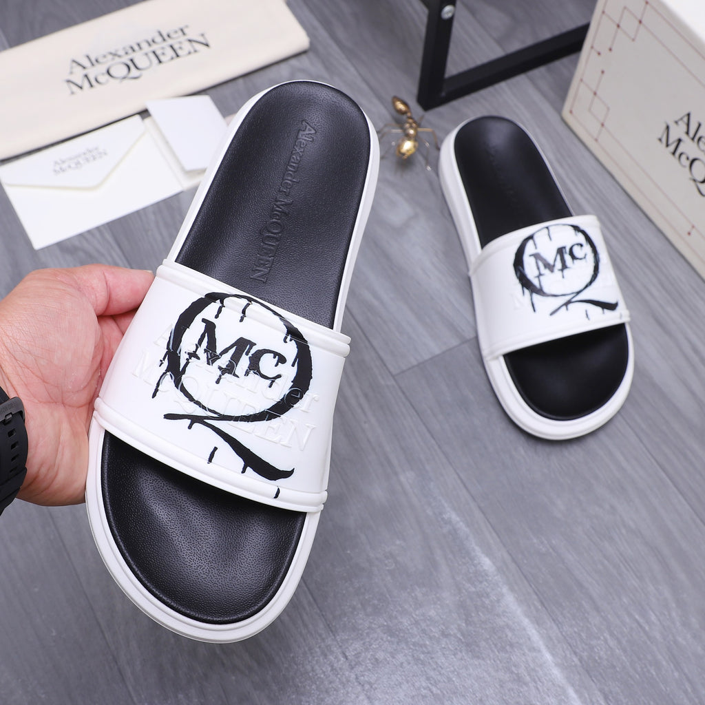 Alexander McQueen slide sandals, white strap over black footbed with MC logo on top