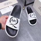 Alexander McQueen slide sandals, white strap over black footbed with MC logo on top