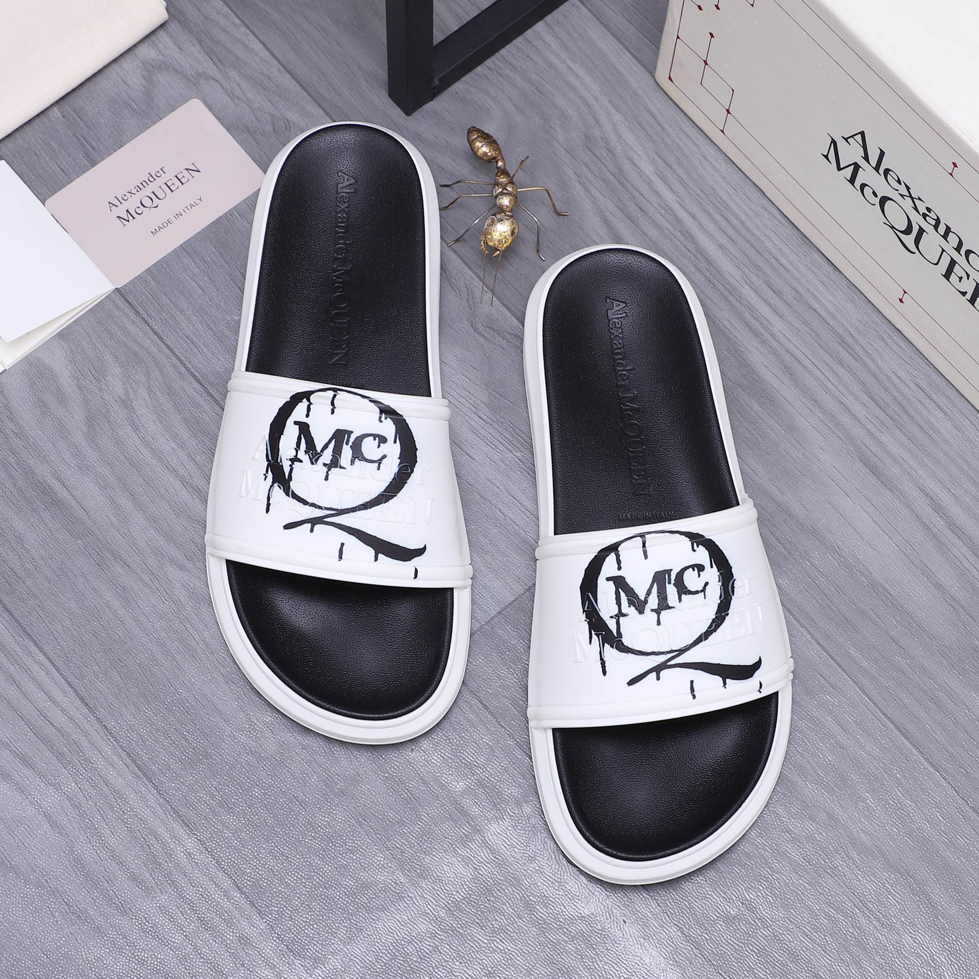 Alexander McQueen slide sandals, two-tone white straps with black footbed and MC logo
