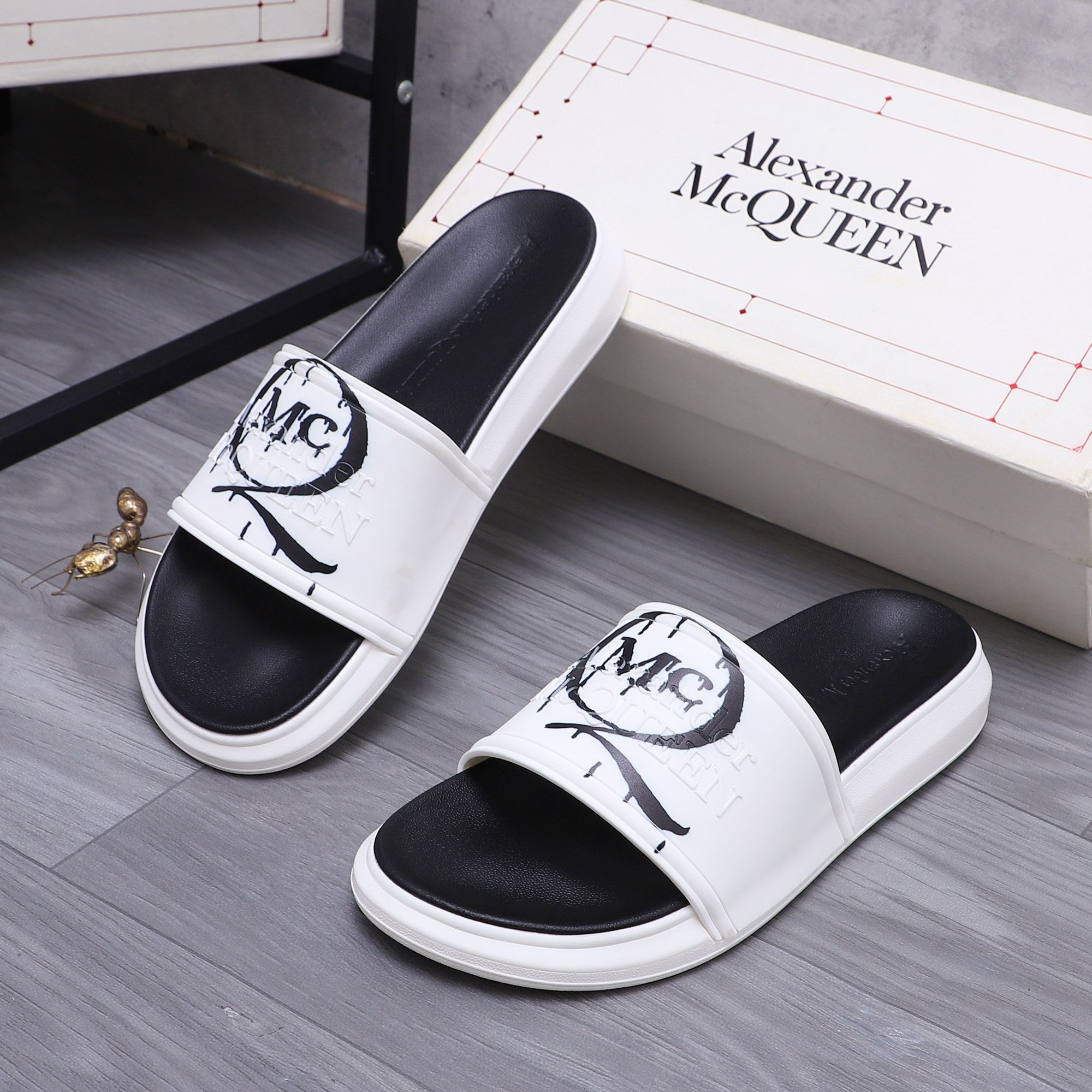Alexander McQueen slide sandals, black footbed with white strap and MC logo detail