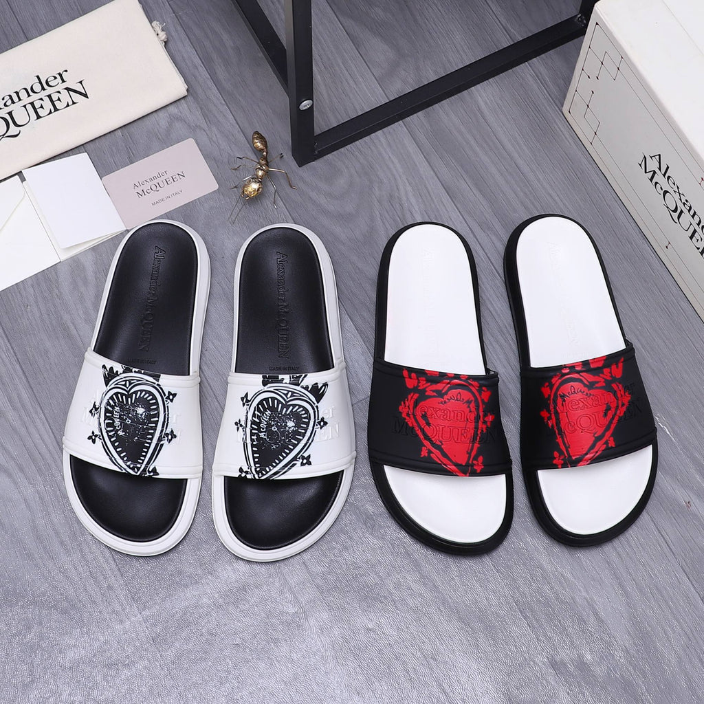 Slide sandals set with white footbeds and decorative black straps in red or white