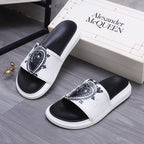 Alexander McQueen slide sandals, white slide with black crest detail and black footbed