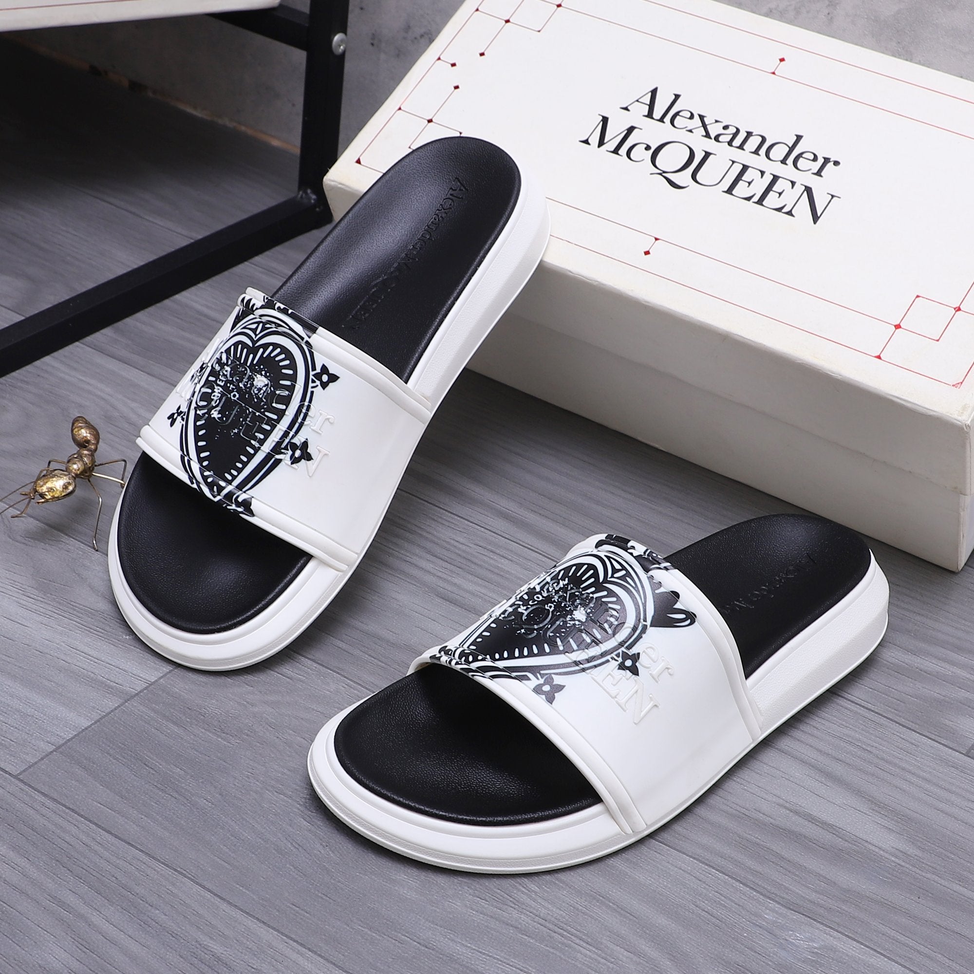 Alexander McQueen slide sandals, white slide with black crest detail and black footbed