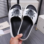 Alexander McQueen slide sandals, white upper with black crest graphic