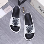 Alexander McQueen slide sandals, white strap with black crest emblem, black footbed