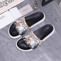 Alexander McQUEEN slide sandals with black uppers, white sole, and beige graphic print
