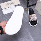Alexander McQUEEN slide sandal outsole view, white sole with embossed logo details