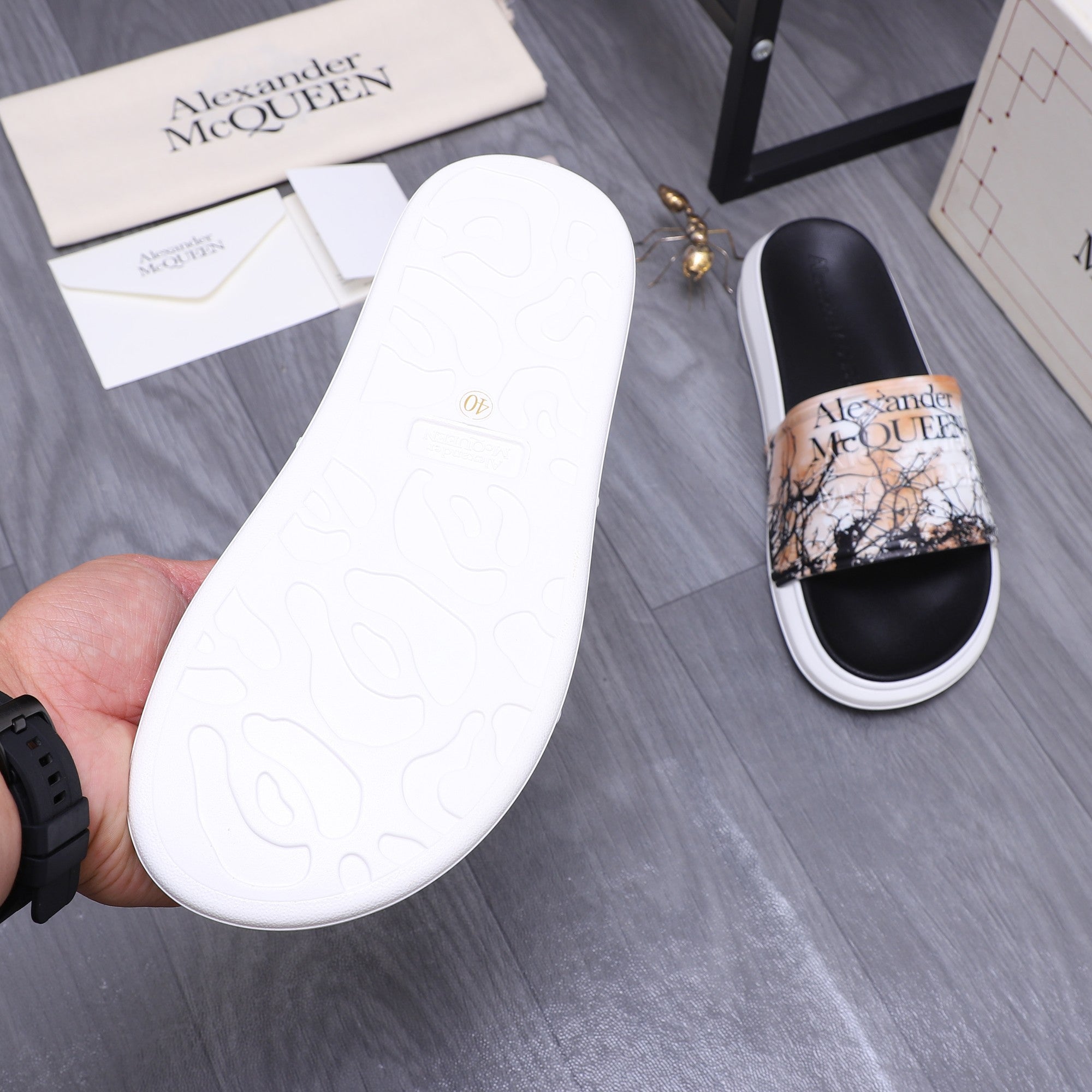 Alexander McQUEEN slide sandal outsole view, white sole with embossed logo details
