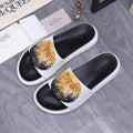 Alexander McQueen slide sandals, black footbeds, white straps, gold floral print.