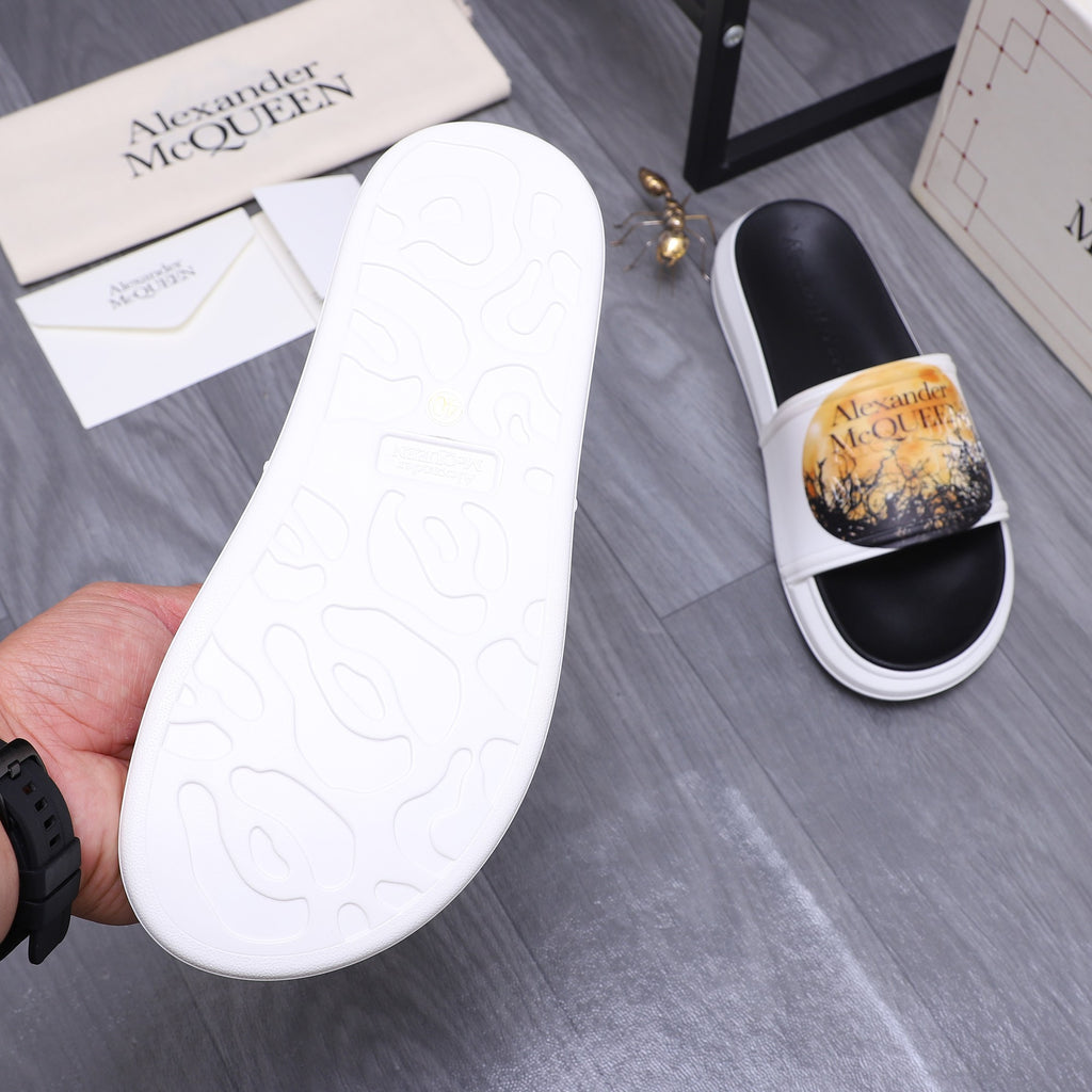 Alexander McQueen slide sandal soles, white rubber outsole with pattern and grip texture.