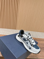 Low-top lace-up sneakers in dark blue and white with padded collar and logo badge