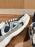 Close-up side profile of dark blue and white sneakers with thick ribbed sole