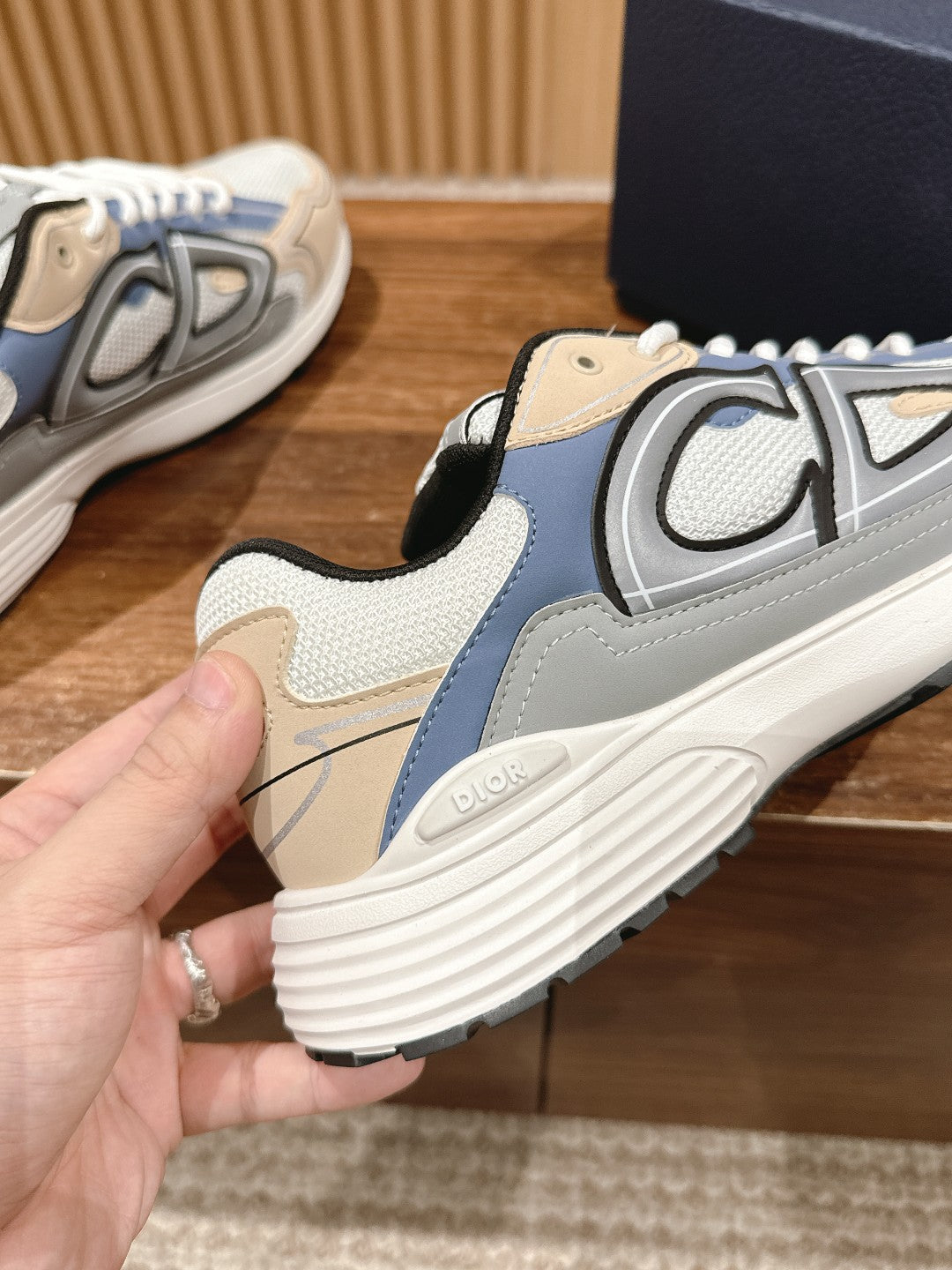 Dior sneaker outsole and heel side, white laces with blue and beige panels
