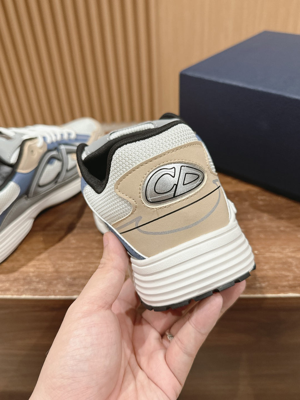 Dior sneaker back view, white sole and textured heel with CD logo patch