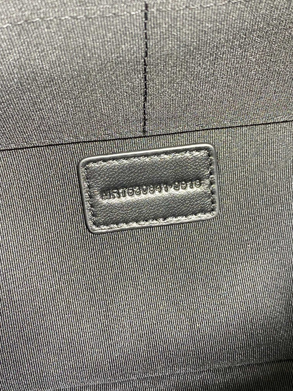 SAINT LAURENT PARIS logo label on the dark bag exterior corner seam