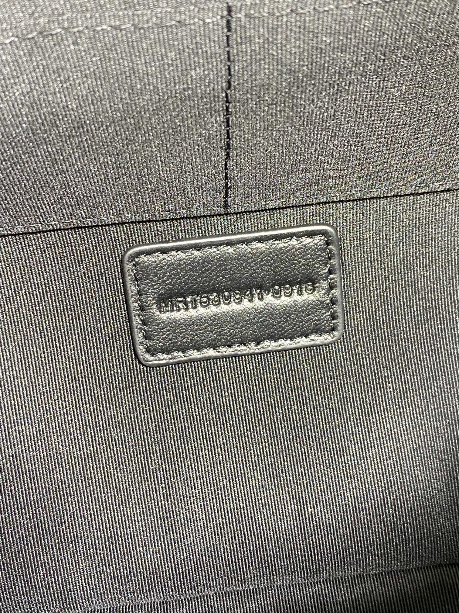 SAINT LAURENT PARIS logo label on the dark bag exterior corner seam