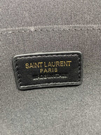 Saint Laurent Paris branding label on dark clutch lining