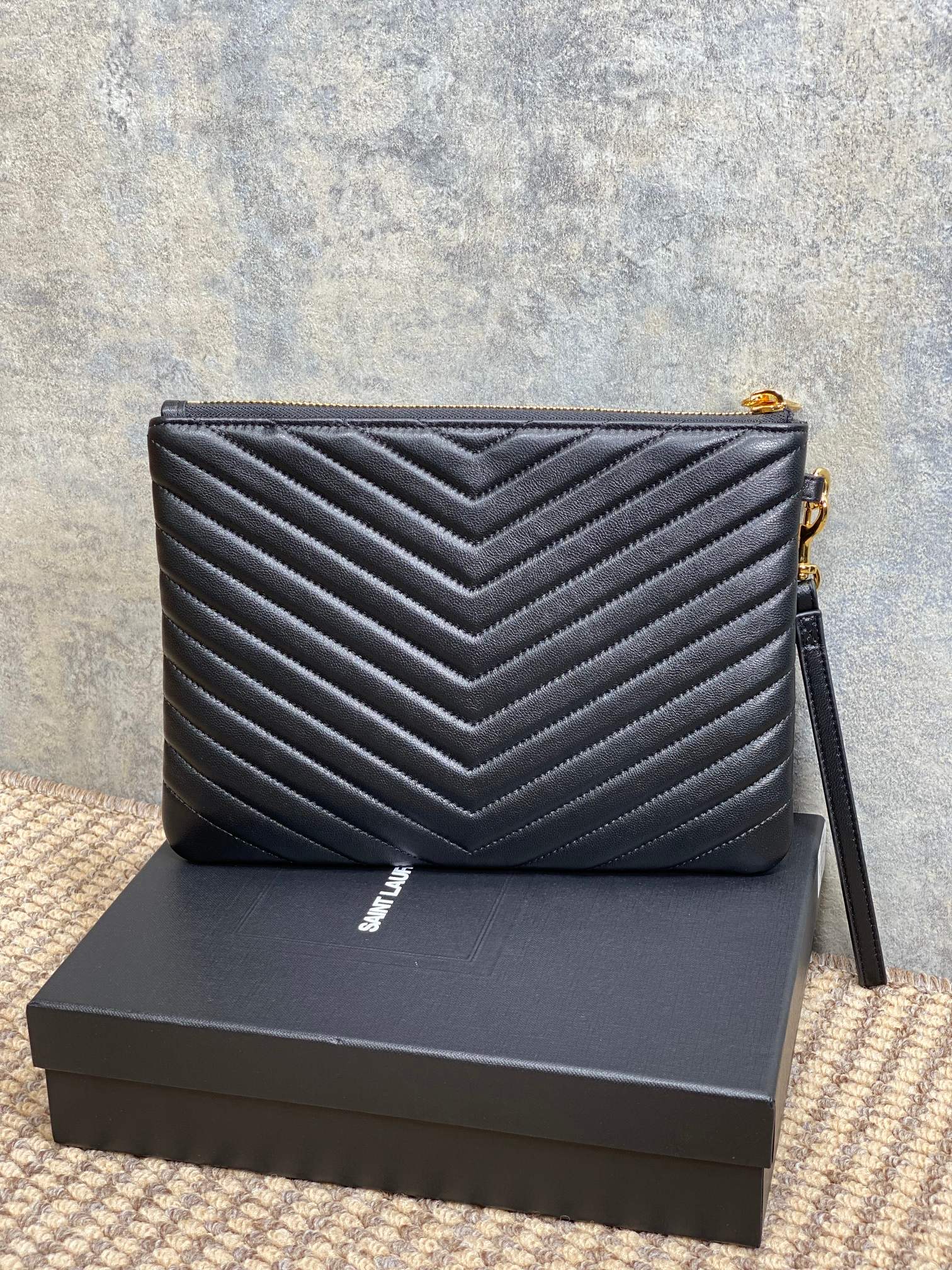 Quilted small YSL bag in dark blue with chevron stitching and gold chain shoulder strap