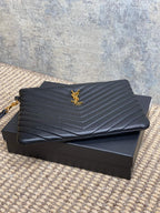 Quilted small bag with YSL logo on front, chevron pattern, gold hardware and zipper