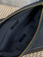 Open interior of quilted small bag with zipper track and slip pockets in dark lining