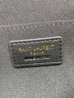 Inner leather label reading SAINT LAURENT PARIS on dark blue small bag