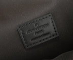 Louis Vuitton leather label close-up on dark strap end with embossed text