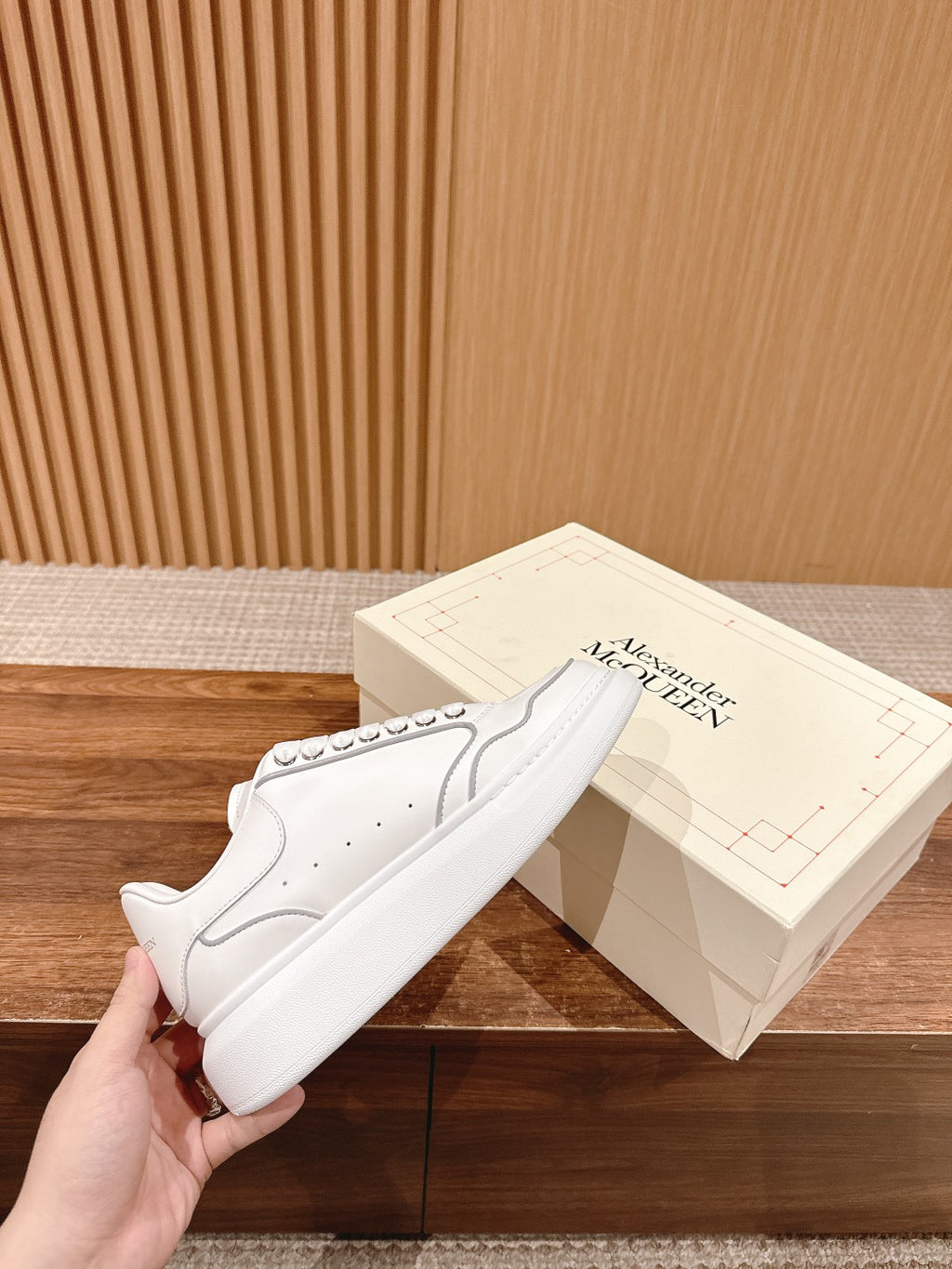 White lace-up low-top sneakers with perforations and stitched panel
