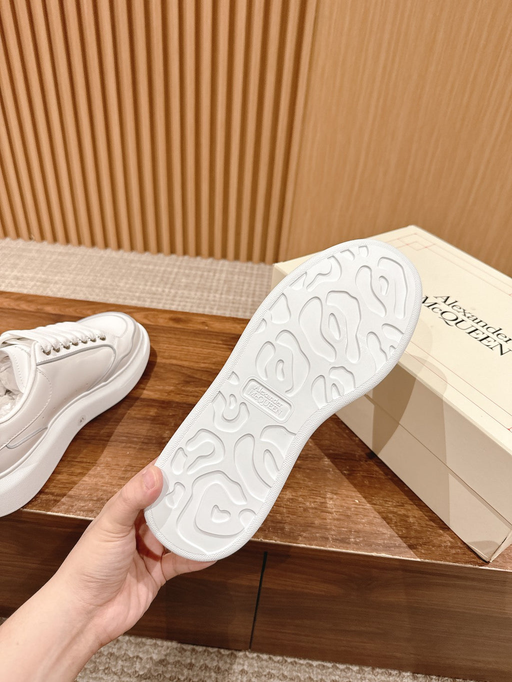 White sneaker outsole with textured tread pattern and sidewall stitching