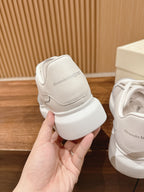 White leather sneaker heel with embossed Alexander McQueen logo patch