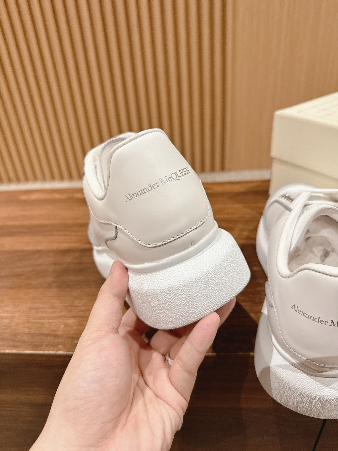 White leather sneaker heel with embossed Alexander McQueen logo patch