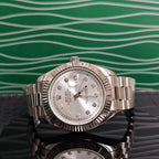 Rolex wristwatch with silver dial and metal bracelet, close-up front view