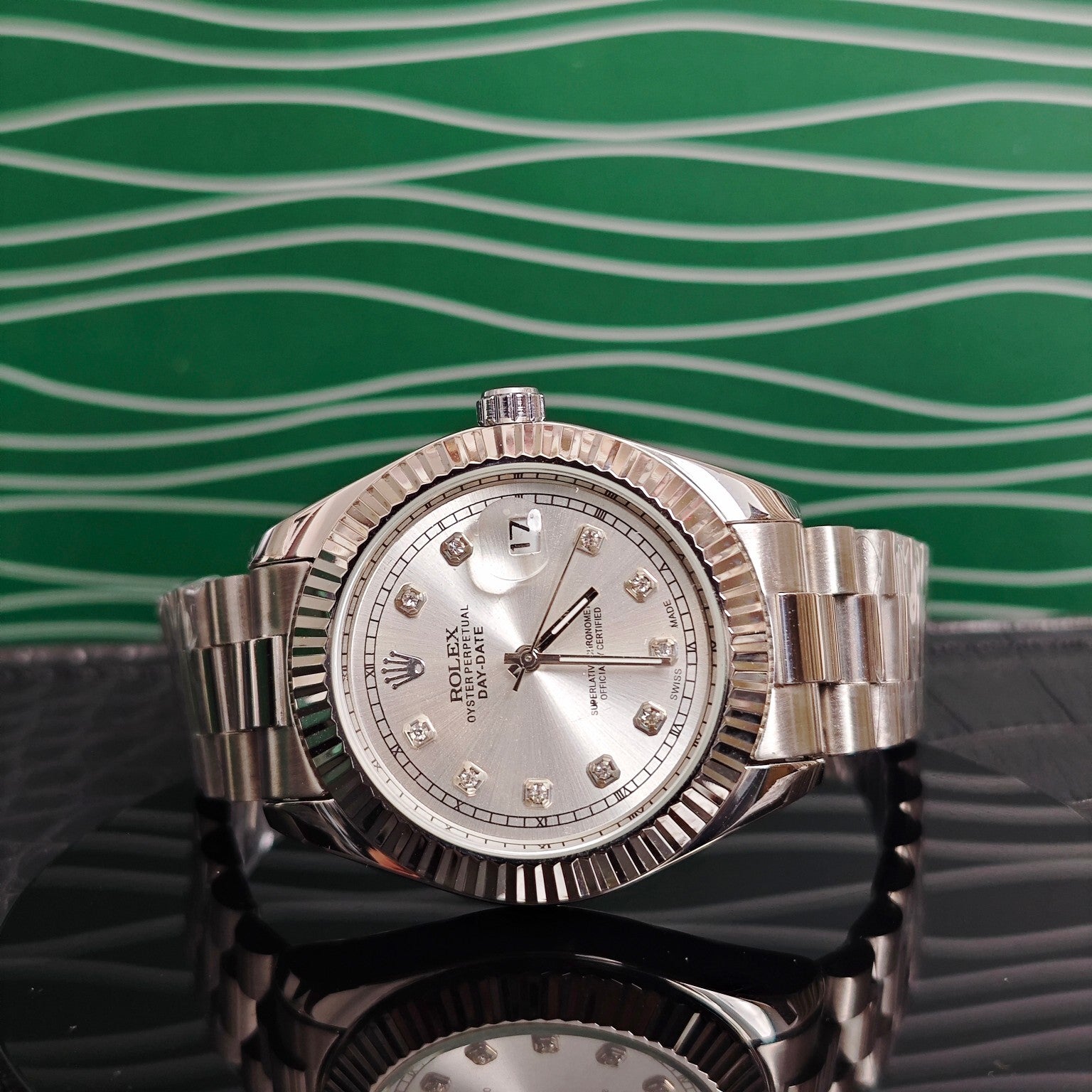 Rolex wristwatch with silver dial and metal bracelet, close-up front view