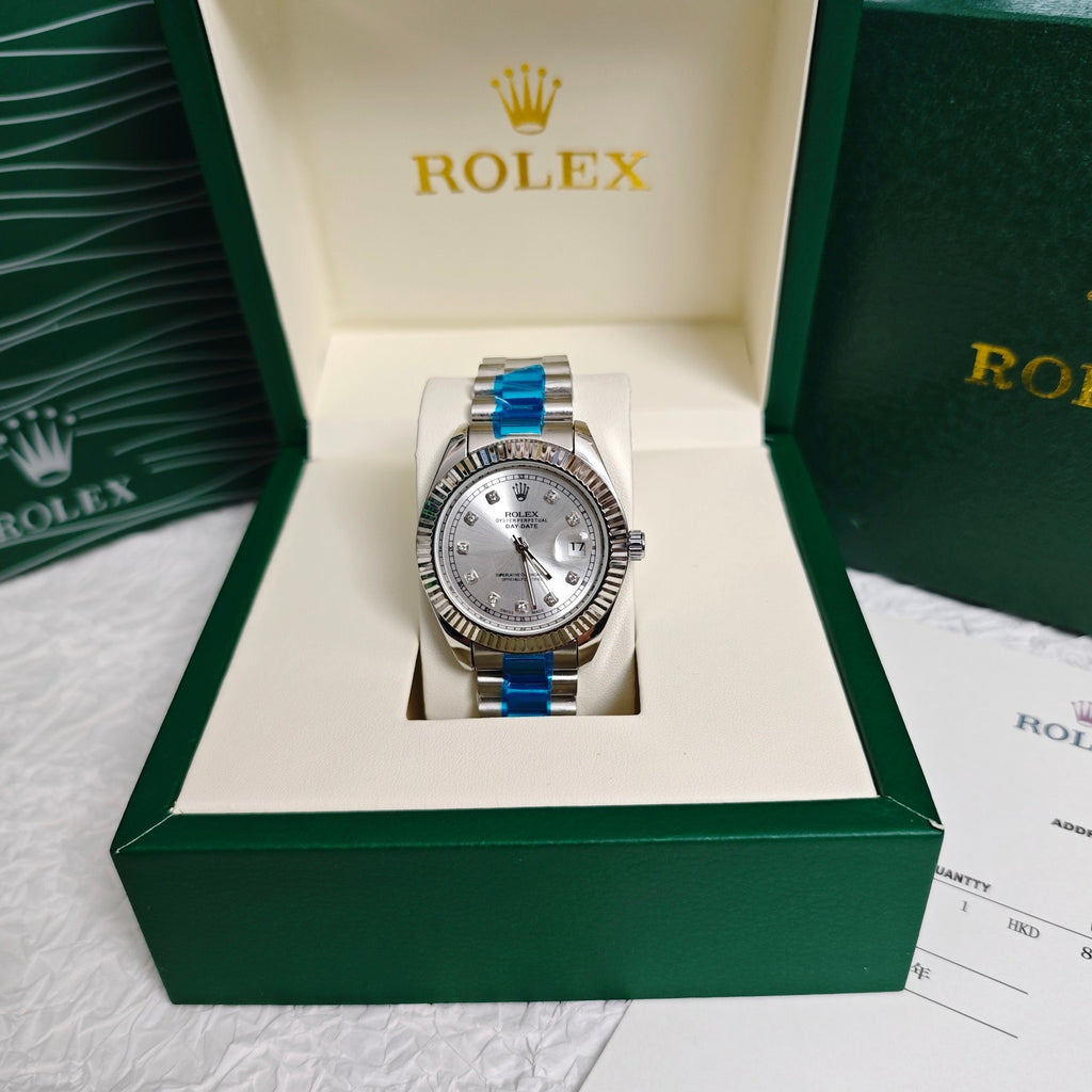 Rolex wristwatch in green box with silver dial and steel bracelet, front view