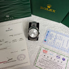 Rolex wristwatch on paperwork with silver dial and steel bracelet, boxed set